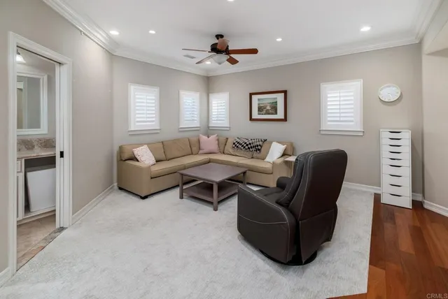 a living room with fireplace furniture and a wooden floor