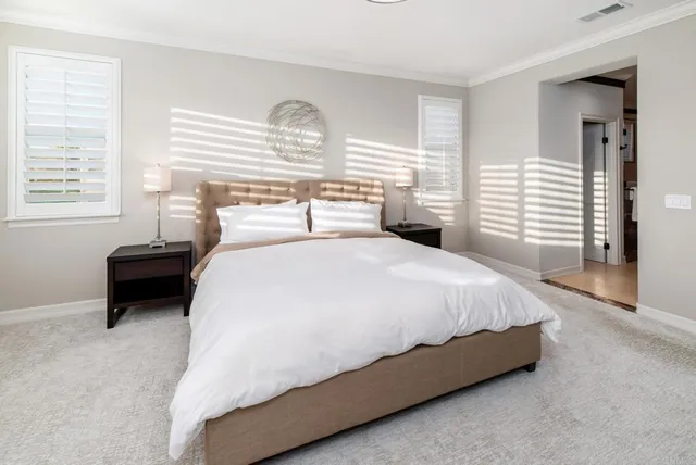 a bedroom with a bed and a night stand