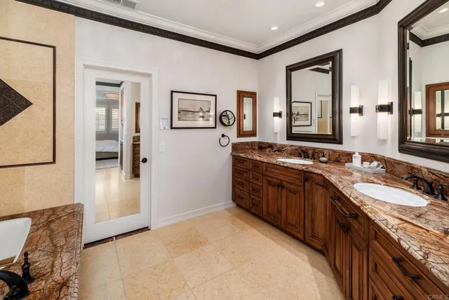 a spacious bathroom with a granite countertop sink and a mirror