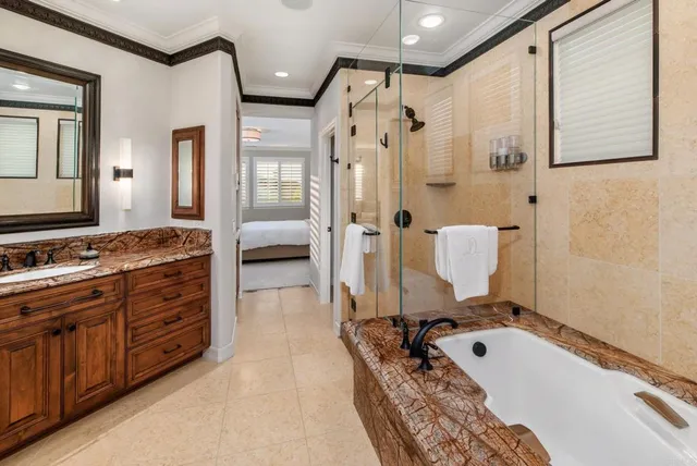 a bathroom with a tub a double vanity sink and mirror