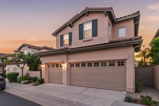 a front view of a house with garage