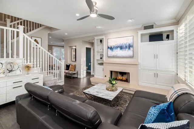 a living room with furniture fireplace and dining room