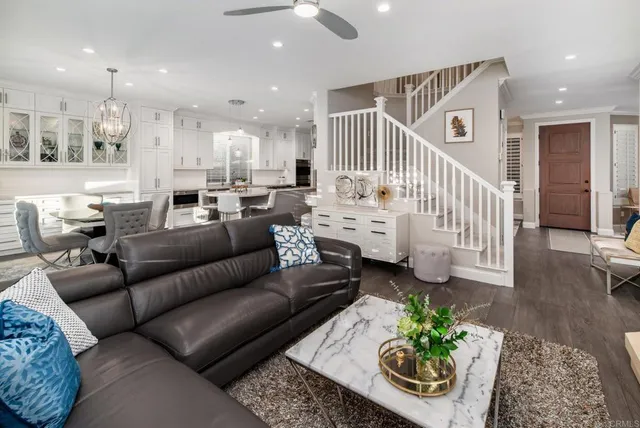 a living room with furniture and a chandelier