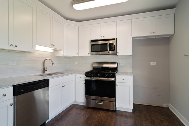 204 Rodenburg Road Roselle, IL 60172 - Photo 2 of 12 a kitchen with granite countertop white cabinets and stainless steel appliances