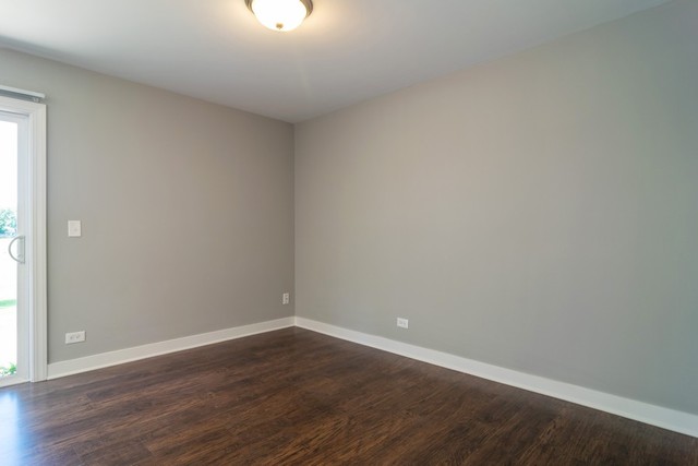 204 Rodenburg Road Roselle, IL 60172 - Photo 3 of 12 a view of an empty room with wooden floor and a window
