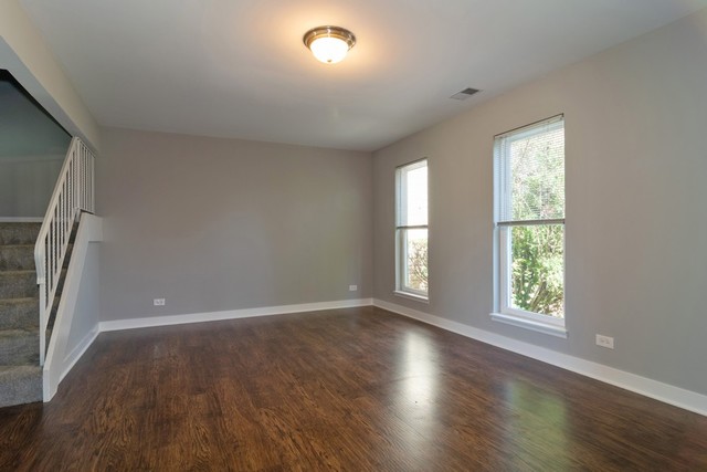 204 Rodenburg Road Roselle, IL 60172 - Photo 5 of 12 an empty room with wooden floor and windows