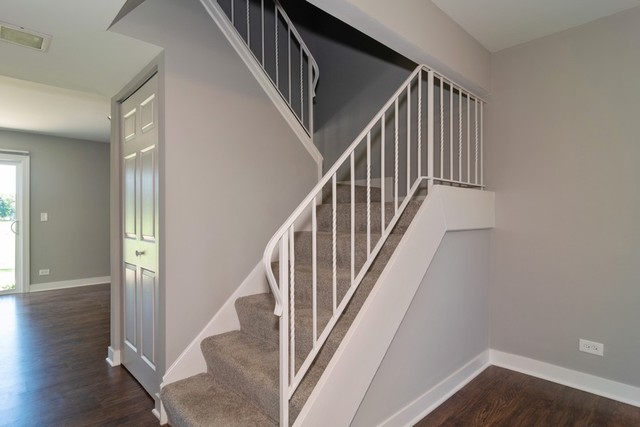 204 Rodenburg Road Roselle, IL 60172 - Photo 6 of 12 a view of staircase with wooden floor and white walls