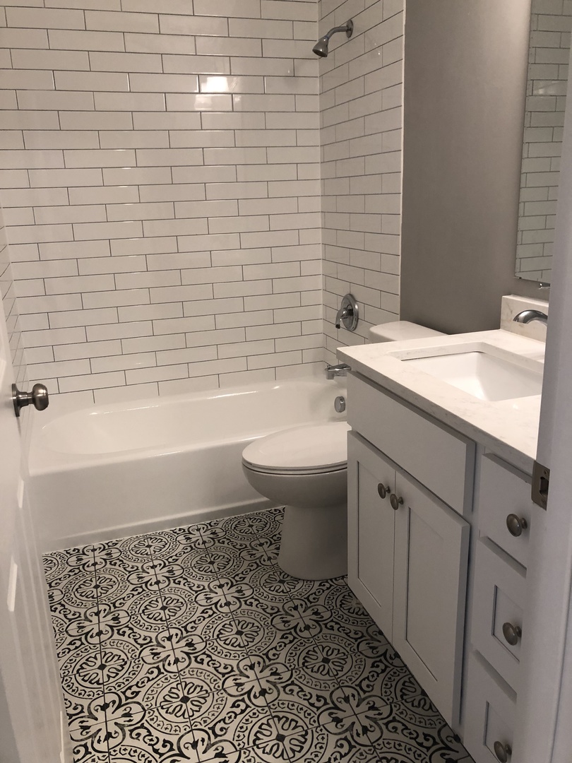 204 Rodenburg Road Roselle, IL 60172 - Photo 8 of 12 a bathroom with a granite countertop toilet a sink a mirror and bathtub