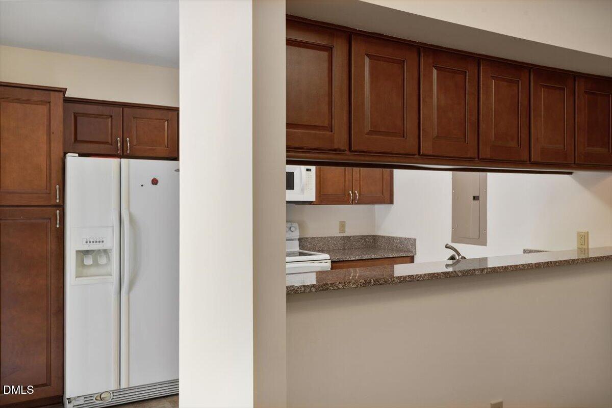 163 Springberry Lane Chapel Hill, NC 27517 - Photo 4 of 32 a kitchen with stainless steel appliances a refrigerator and cabinets