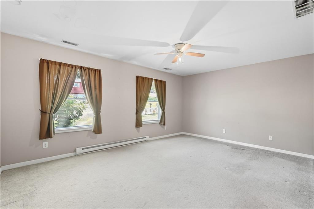 2430 Coulterville Road Irwin, PA 15642 - Photo 20 of 34 an empty room with windows and ceiling fan