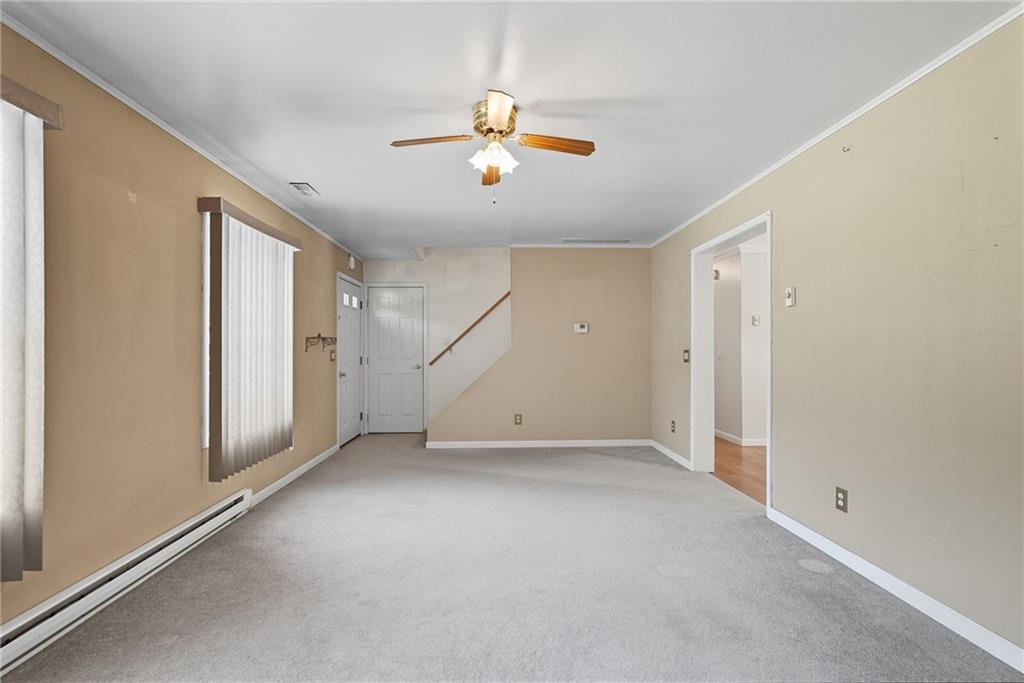 2430 Coulterville Road Irwin, PA 15642 - Photo 24 of 34 a view of a livingroom with a ceiling fan and window