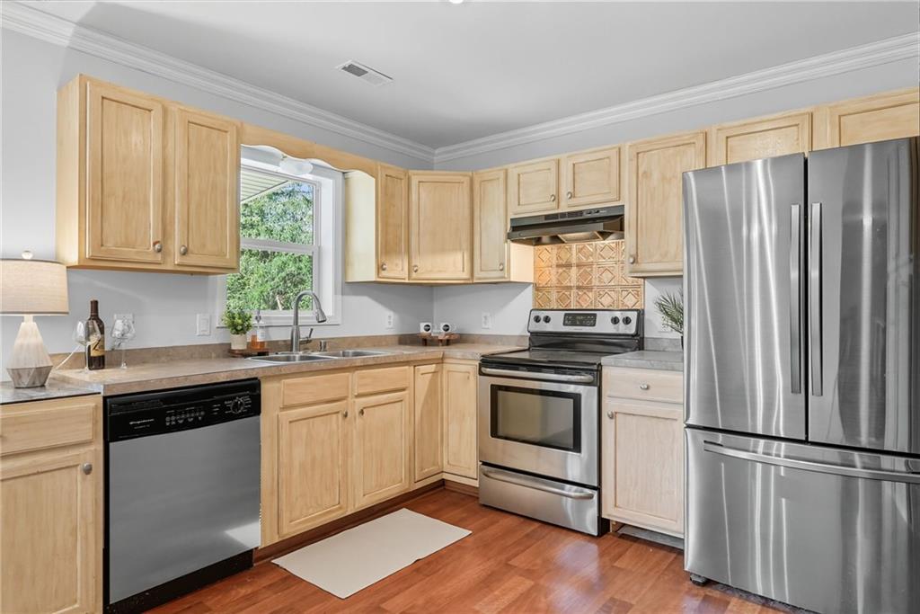 2430 Coulterville Road Irwin, PA 15642 - Photo 9 of 34 a kitchen with granite countertop stainless steel appliances a sink cabinets and a window