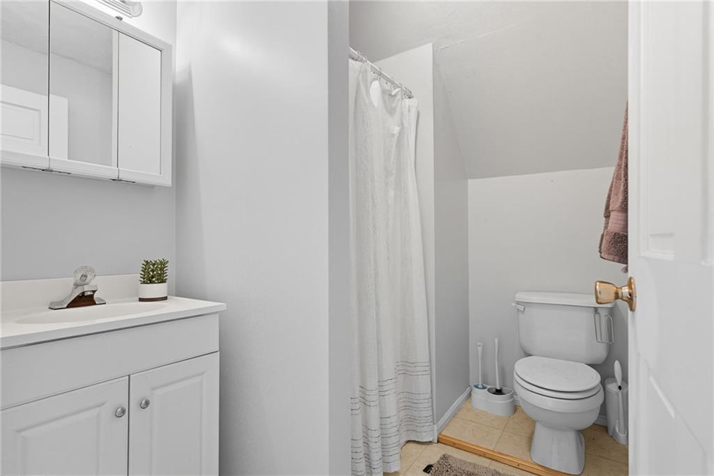 2430 Coulterville Road Irwin, PA 15642 - Photo 10 of 34 a bathroom with a toilet sink vanity and mirror