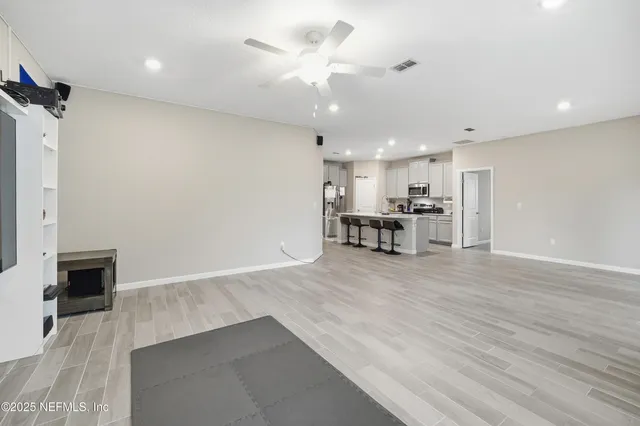 a view of a kitchen with a sink and a refrigerator