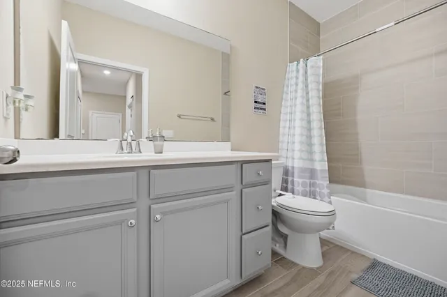 a bathroom with a sink toilet a mirror and shower