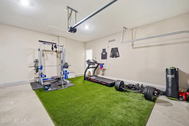a view of a room with gym equipment and a table