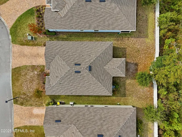 an aerial view of a house with a yard