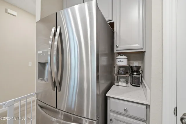 a kitchen with a refrigerator and cabinets