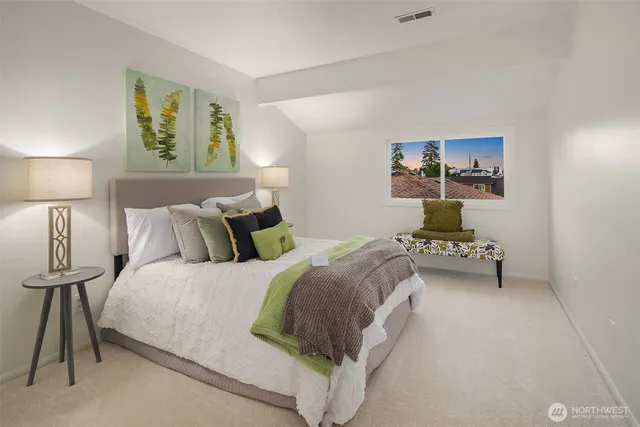 a bedroom with a bed and a lamp