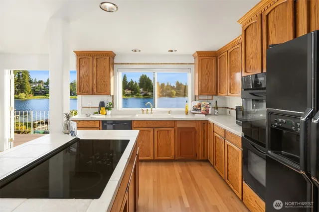 a kitchen with stainless steel appliances a sink stove and refrigerator