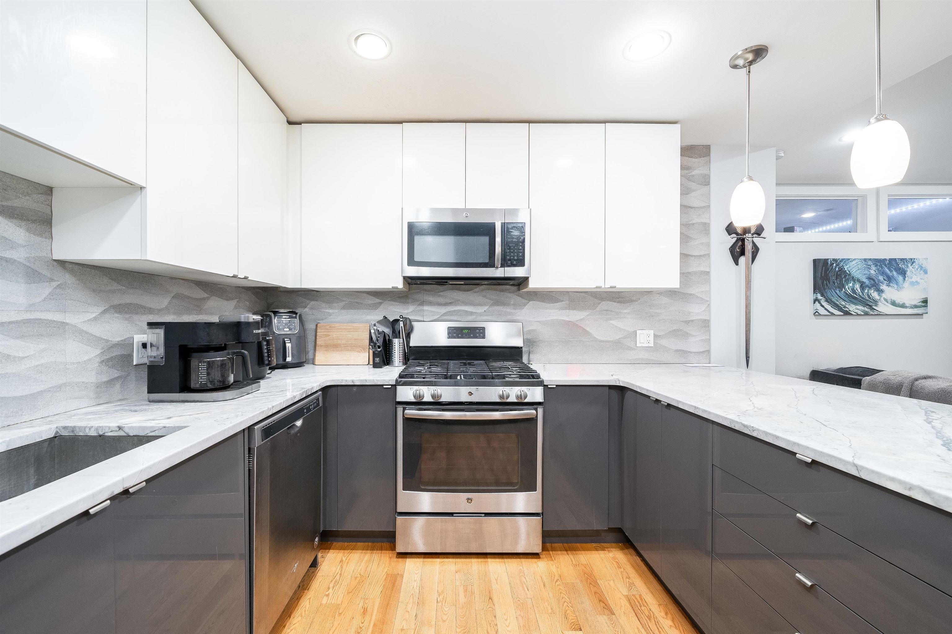 516 Monroe Street, Unit 3 Hoboken, NJ 07030 - Photo 11 of 13 a kitchen with a sink a stove and cabinets