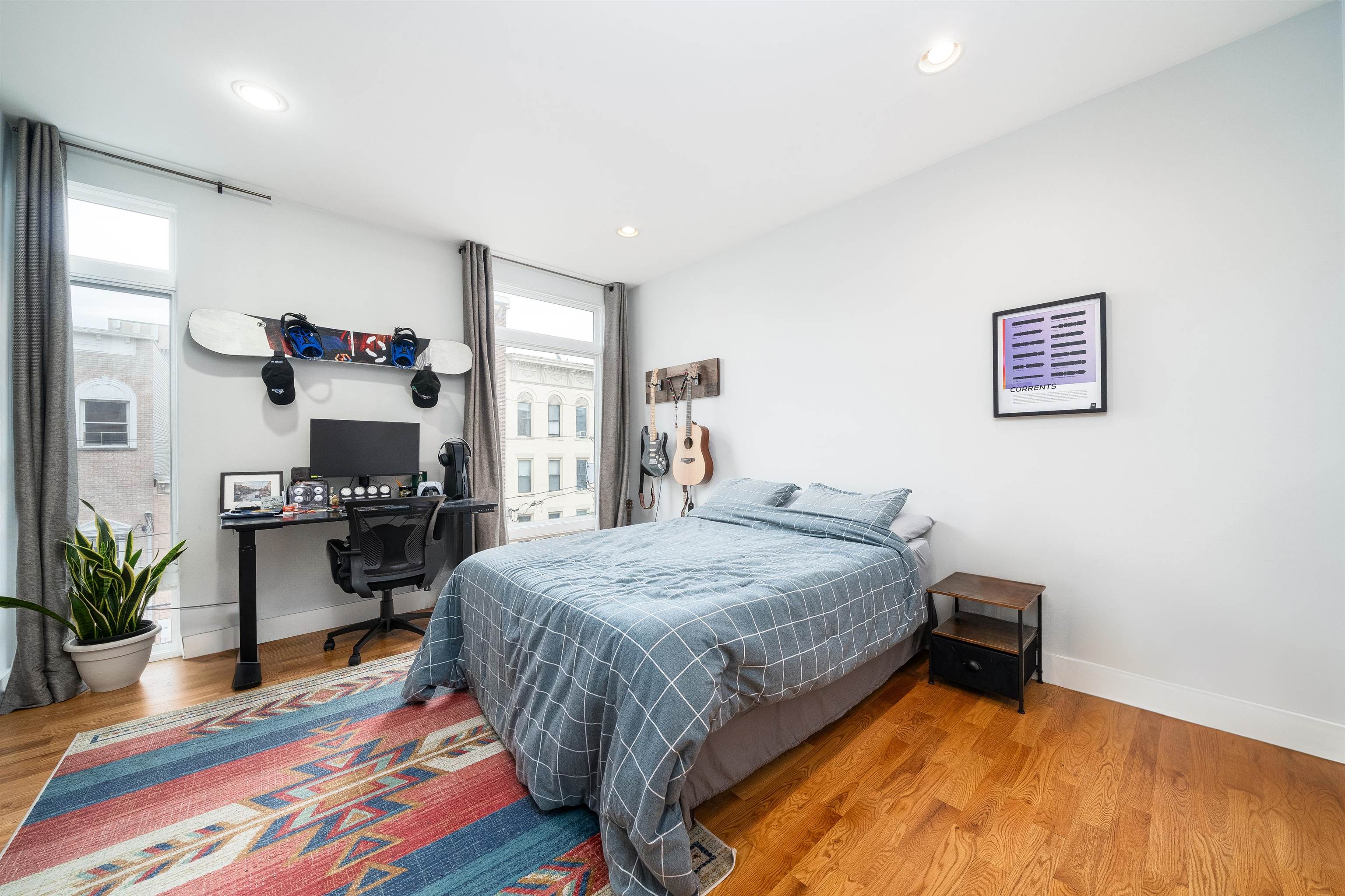 516 Monroe Street, Unit 3 Hoboken, NJ 07030 - Photo 2 of 13 a spacious bedroom with a bed and a table in it