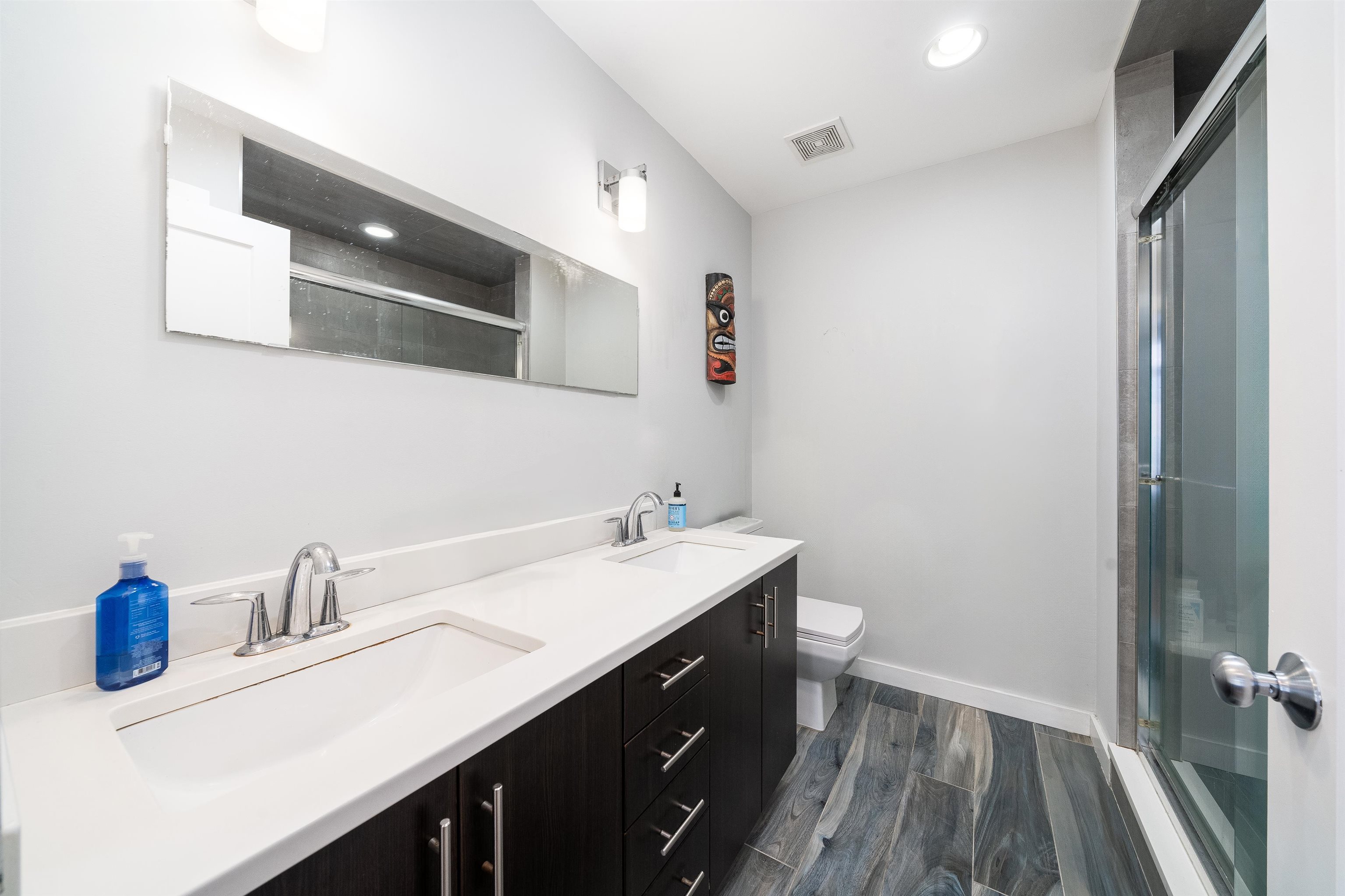 516 Monroe Street, Unit 3 Hoboken, NJ 07030 - Photo 3 of 13 a bathroom with a sink and a mirror