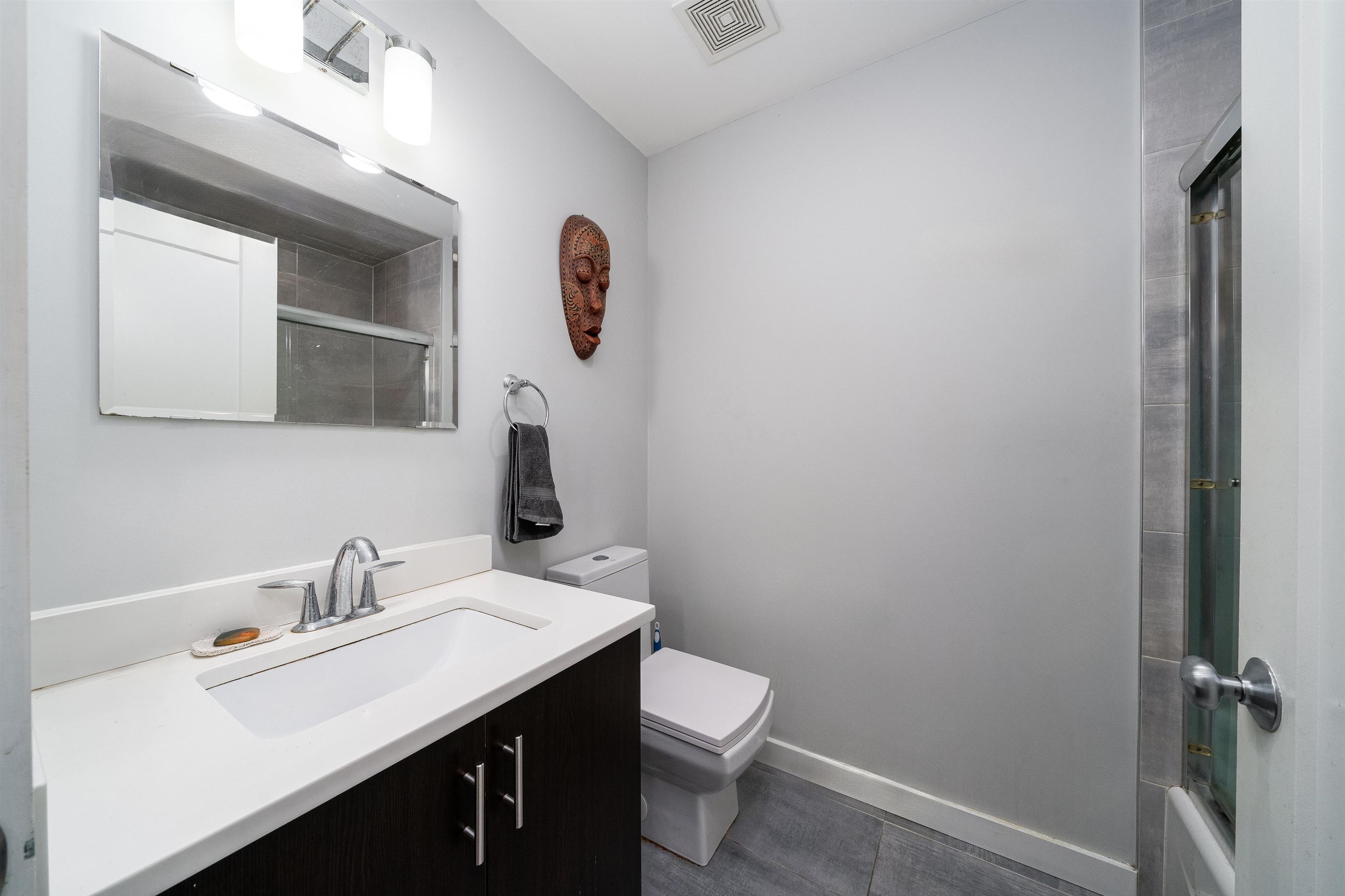 516 Monroe Street, Unit 3 Hoboken, NJ 07030 - Photo 5 of 13 a bathroom with a sink vanity and a toilet