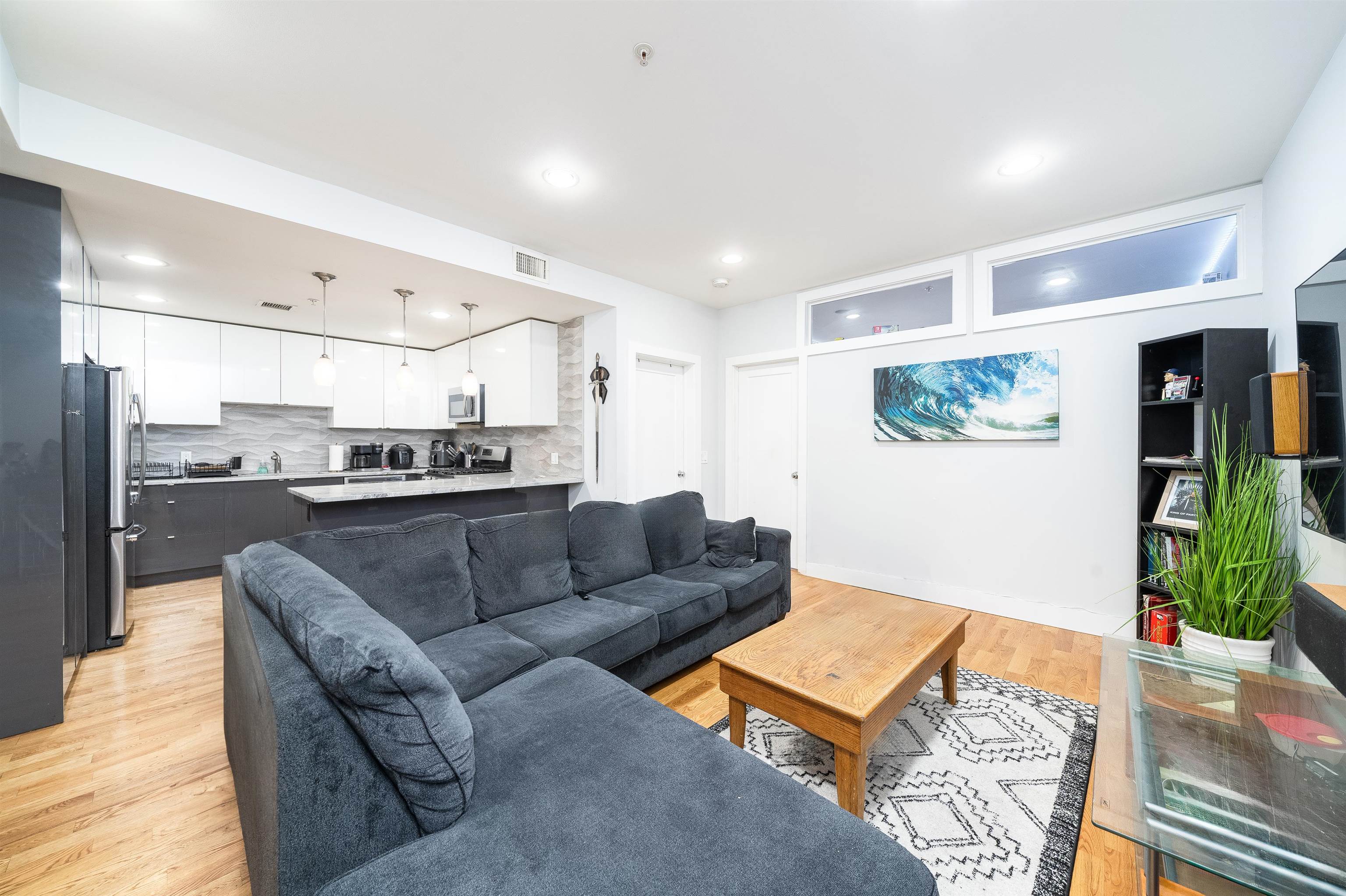 516 Monroe Street, Unit 3 Hoboken, NJ 07030 - Photo 7 of 13 a living room with furniture and kitchen view