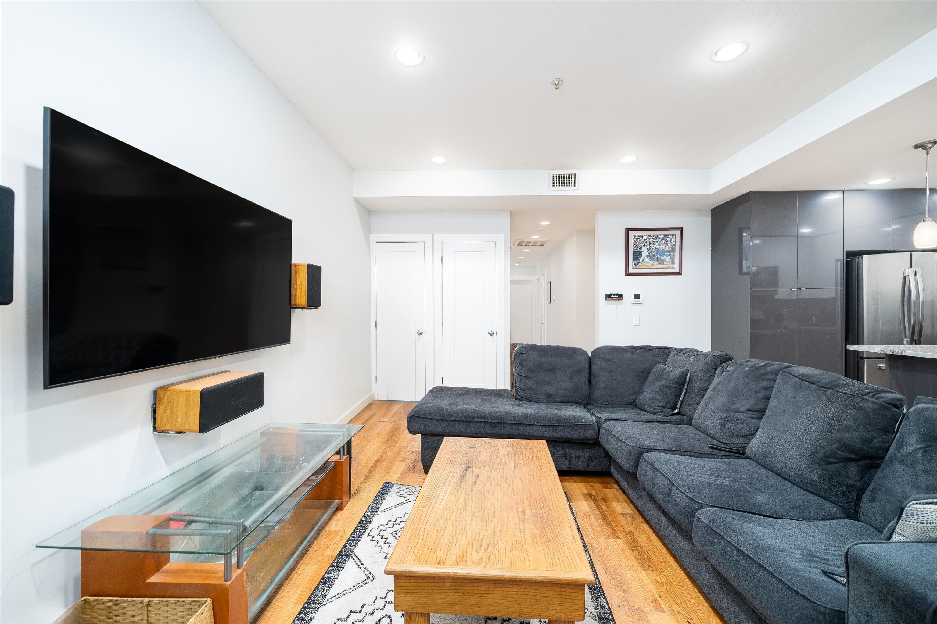 516 Monroe Street, Unit 3 Hoboken, NJ 07030 - Photo 8 of 13 a living room with furniture and a flat screen tv