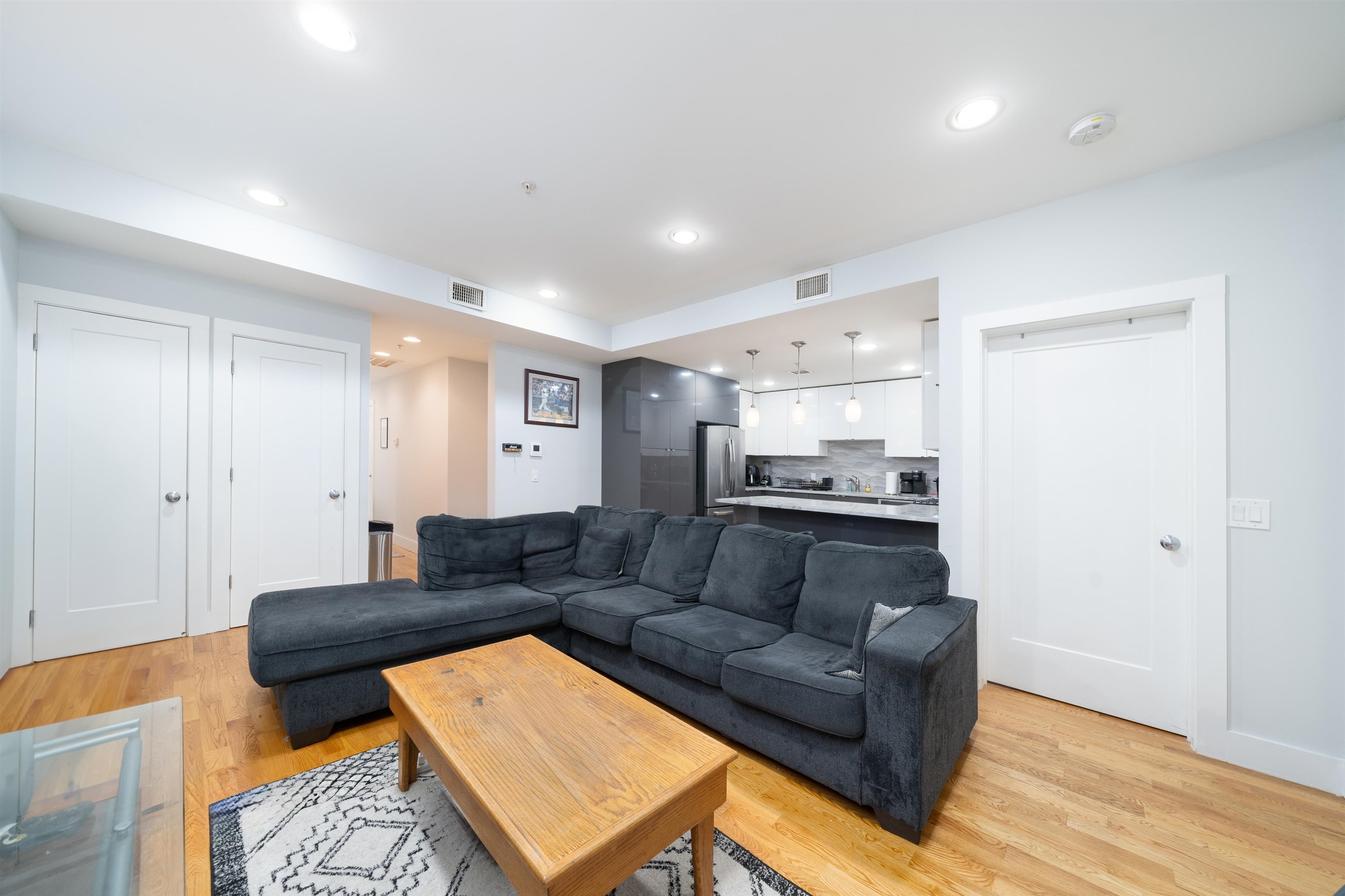 516 Monroe Street, Unit 3 Hoboken, NJ 07030 - Photo 9 of 13 a living room with furniture and a wooden floor