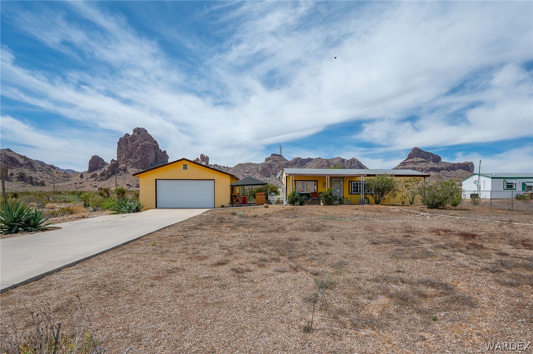 2465 Egar Road Golden Valley, AZ 86413 - Photo 68 of 98 This property features a detached garage with a white door and a paved driveway