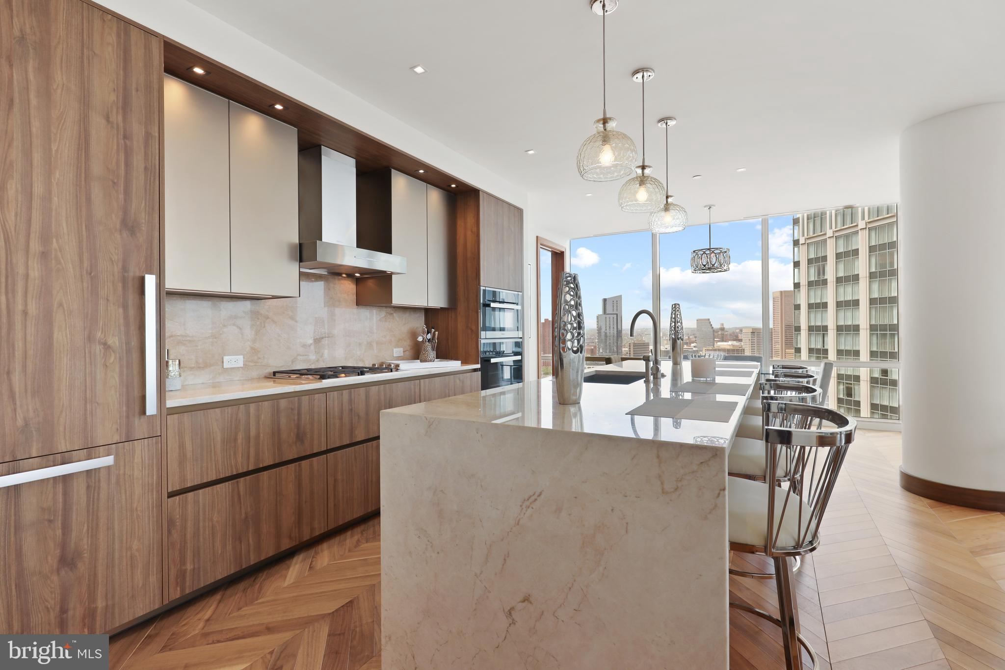 300 International Drive, Unit 2403 Baltimore, MD 21202 - Photo 11 of 36 a kitchen with stainless steel appliances granite countertop a sink dishwasher a refrigerator white cabinets and wooden floor