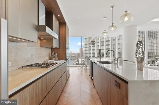 a kitchen with stainless steel appliances a sink stove and cabinets