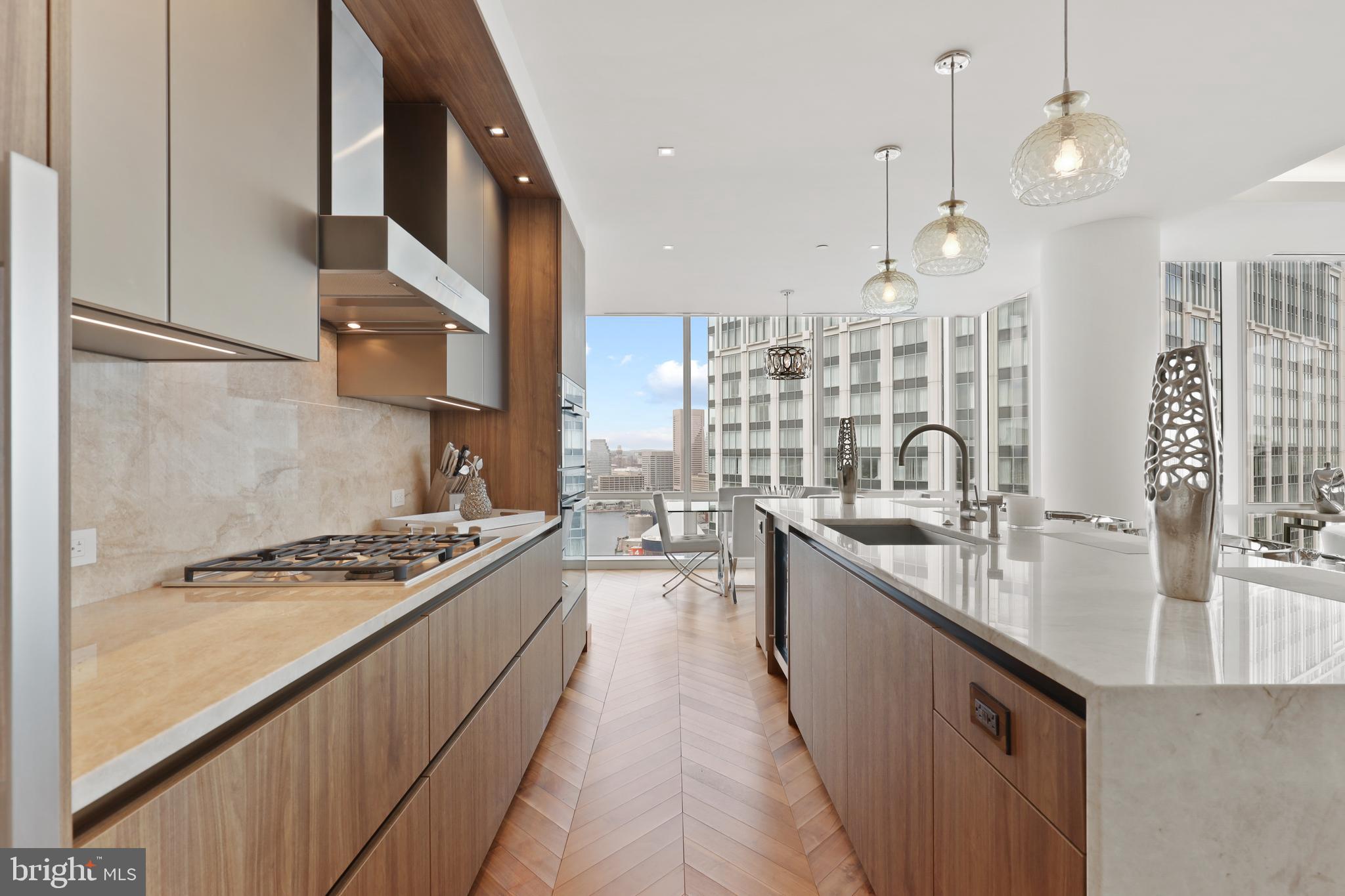 300 International Drive, Unit 2403 Baltimore, MD 21202 - Photo 12 of 36 a kitchen with stainless steel appliances a sink stove and cabinets