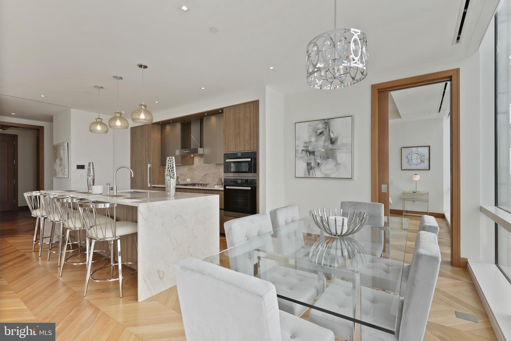 300 International Drive, Unit 2403 Baltimore, MD 21202 - Photo 14 of 36 a dining room with wooden floor and chandelier