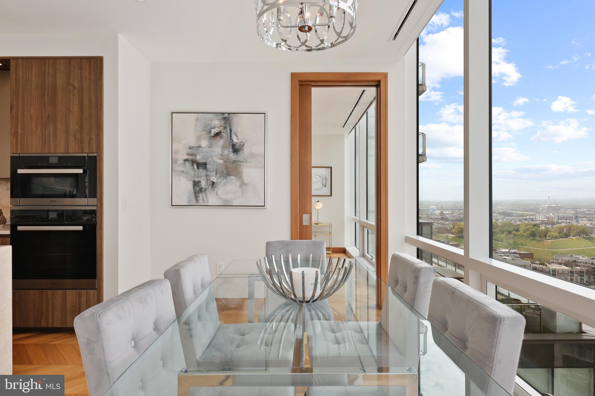 300 International Drive, Unit 2403 Baltimore, MD 21202 - Photo 15 of 36 a living room with furniture and a floor to ceiling window