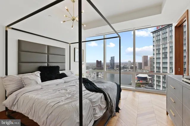 a bedroom with a bed and a large window