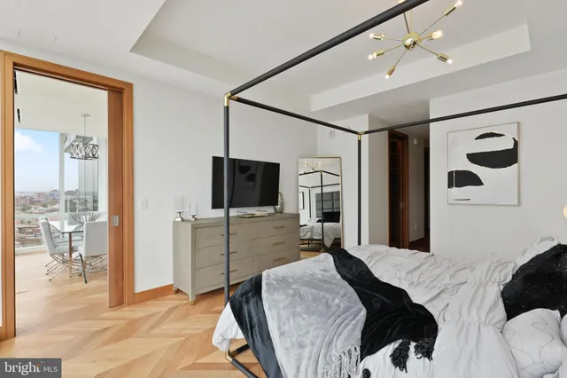 a bedroom with a bed and glass door