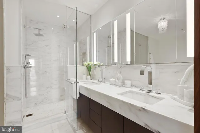 a bathroom with a sink double vanity and shower