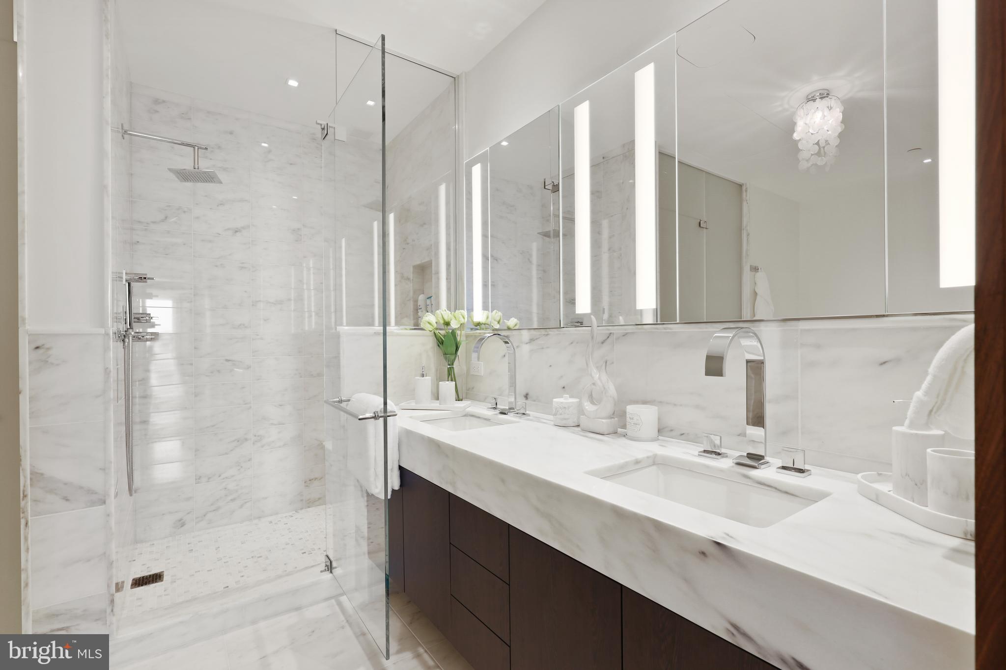 300 International Drive, Unit 2403 Baltimore, MD 21202 - Photo 21 of 36 a bathroom with a sink double vanity and shower