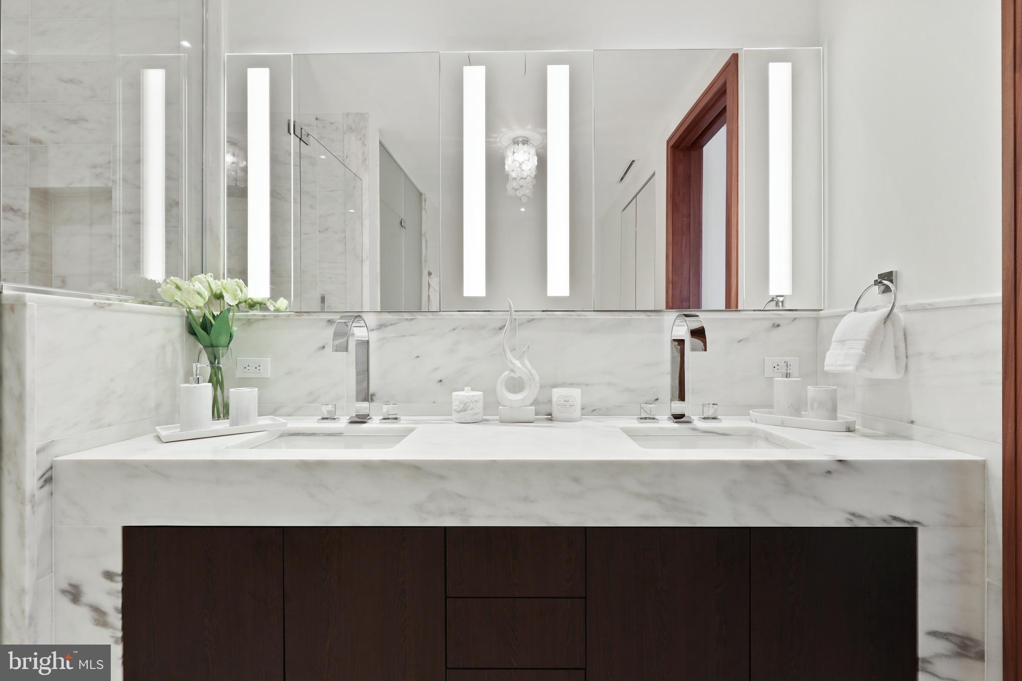 300 International Drive, Unit 2403 Baltimore, MD 21202 - Photo 23 of 36 a bathroom with a sink and a mirror