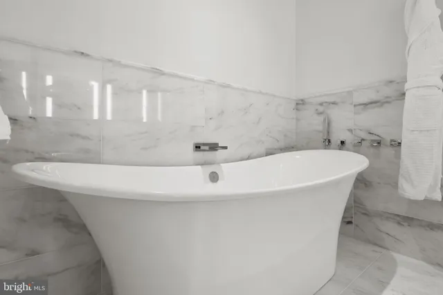 a white bath tub sitting in a bathroom