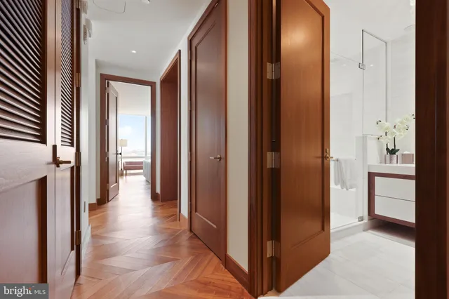 a view of a hallway with wooden floor