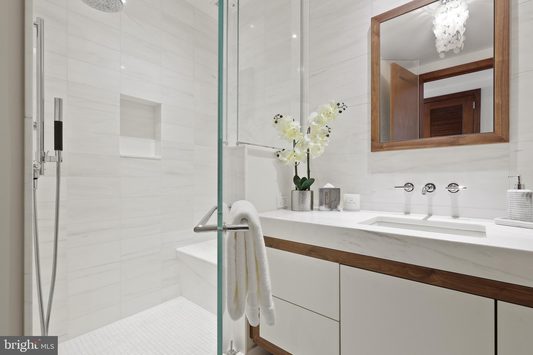 300 International Drive, Unit 2403 Baltimore, MD 21202 - Photo 27 of 36 a bathroom with a sink and a mirror