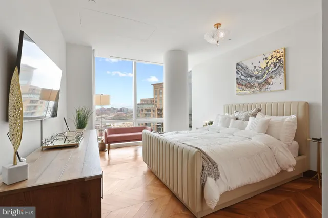 a bedroom with a large bed and a large window