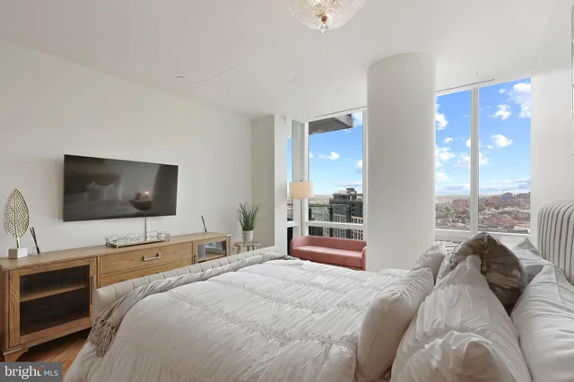 a bedroom with a bed and a flat screen tv