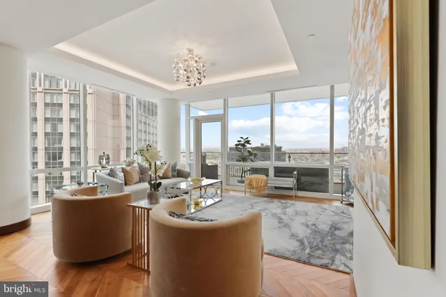 a living room with furniture and large windows