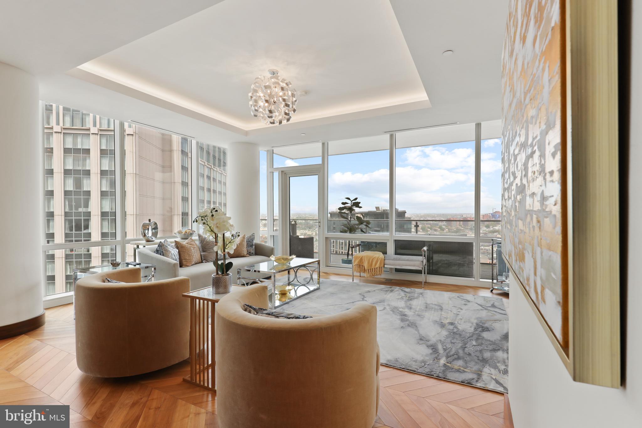 300 International Drive, Unit 2403 Baltimore, MD 21202 - Photo 7 of 36 a living room with furniture and large windows