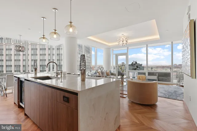 a kitchen with sink and living room view